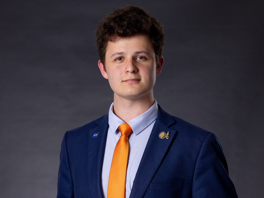 Mikhail Mikhaylov wears a blue suit and looks at the camera.