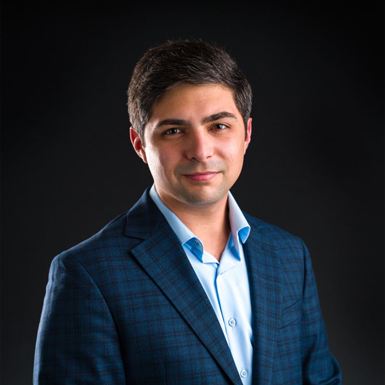 A professional headshot of Braden BLue in front of a black background