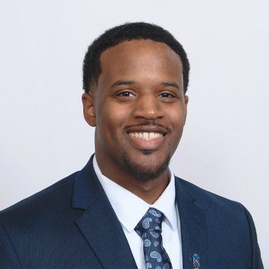 A professional headshot of Nigel Richardson in front of a white background.