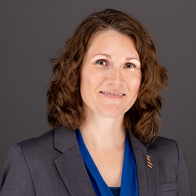 A professional headshot of Stephanie McBride in front of a grey background.